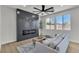 Contemporary living room showcasing a stylish fireplace, neutral color palette, and an abundance of natural light at 6282 Dollar Bill Ct, Las Vegas, NV 89141