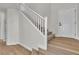 Elegant staircase with white railing, complemented by hardwood floors and a bright, welcoming entryway at 6282 Dollar Bill Ct, Las Vegas, NV 89141