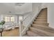 Light-filled foyer showcasing a carpeted staircase, neutral walls, and inviting interior spaces with ample natural light at 6282 Dollar Bill Ct, Las Vegas, NV 89141
