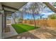 Spacious backyard featuring a well-kept lawn, mature trees, and a concrete patio at 6320 Dayton Ave, Las Vegas, NV 89107