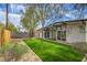 Serene backyard showcasing lush lawn and a modern exterior with large sliding glass doors at 6320 Dayton Ave, Las Vegas, NV 89107