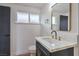Stylish bathroom featuring a modern vanity with gold hardware, a toilet, and a window at 6320 Dayton Ave, Las Vegas, NV 89107