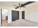 Cozy bedroom showcases a ceiling fan, beam detail, and a bathroom, creating a comfortable retreat at 6320 Dayton Ave, Las Vegas, NV 89107