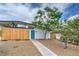 Landscaped front yard of a modern home featuring desert-friendly design and a blue front door at 6320 Dayton Ave, Las Vegas, NV 89107
