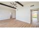 Spacious living area with neutral walls, wood floors, and modern ceiling fan at 6320 Dayton Ave, Las Vegas, NV 89107