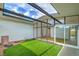 Private outdoor atrium with synthetic grass, modern design, and lots of natural light streaming through windows at 6320 Dayton Ave, Las Vegas, NV 89107