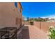 A long, narrow backyard has a gated fence and low maintenance landscaping at 6620 Tulip Falls Dr, Henderson, NV 89011