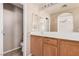 This bathroom offers wood cabinets, a large countertop and dual mirrors at 6620 Tulip Falls Dr, Henderson, NV 89011