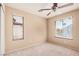 This carpeted bedroom has two windows, bringing in natural light at 6620 Tulip Falls Dr, Henderson, NV 89011