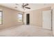 This primary bedroom features neutral carpet and ample light from the large window at 6620 Tulip Falls Dr, Henderson, NV 89011