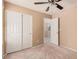 This is a cozy bedroom with a ceiling fan and closet space at 6620 Tulip Falls Dr, Henderson, NV 89011