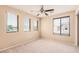 Bright bedroom with three windows and a ceiling fan at 6620 Tulip Falls Dr, Henderson, NV 89011
