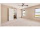This bedroom features neutral carpet and a large window for ample natural light at 6620 Tulip Falls Dr, Henderson, NV 89011