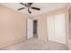 A comfy bedroom features a ceiling fan and closet with sliding doors at 6620 Tulip Falls Dr, Henderson, NV 89011