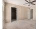 This carpeted bedroom offers a ceiling fan and walk in closet at 6620 Tulip Falls Dr, Henderson, NV 89011