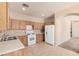 Well-lit kitchen featuring wooden cabinets and standard appliances at 6620 Tulip Falls Dr, Henderson, NV 89011