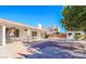 Wide open backyard with gravel and brick features a covered patio with furniture at 708 Canyon Country Cir, Henderson, NV 89002