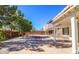 Spacious backyard features a covered patio, rock landscaping, and privacy walls at 708 Canyon Country Cir, Henderson, NV 89002