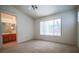 Bright bedroom with neutral carpet, ceiling fan, and a view to the bathroom ensuite at 708 Canyon Country Cir, Henderson, NV 89002