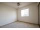 This is a basic carpeted bedroom with a ceiling fan and window letting in lots of light at 708 Canyon Country Cir, Henderson, NV 89002
