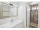 Bright bathroom boasts updated vanity with marble top and shower with decorative tile at 7139 Mountain Moss Dr, Las Vegas, NV 89147