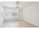 Bright bedroom features neutral tile floors, a ceiling fan and large window with blinds at 7139 Mountain Moss Dr, Las Vegas, NV 89147