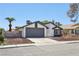 Attractive home with dark gray garage and well manicured landscaping at 7139 Mountain Moss Dr, Las Vegas, NV 89147