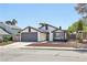 Home exterior with well-maintained yard and attached two-car garage at 7139 Mountain Moss Dr, Las Vegas, NV 89147