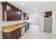 Spacious kitchen features granite countertops, stainless appliances, and dark wood cabinets at 7139 Mountain Moss Dr, Las Vegas, NV 89147