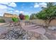 Serene backyard with a rock water feature and a built-in hot tub, perfect for relaxation at 7183 Majestic Bluff Pl, Las Vegas, NV 89113