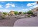 Spacious backyard with desert landscaping and a concrete patio at 7183 Majestic Bluff Pl, Las Vegas, NV 89113