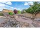 Well-maintained backyard with a spa, rock features, and desert landscaping for a tranquil outdoor experience at 7183 Majestic Bluff Pl, Las Vegas, NV 89113
