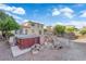 Landscaped backyard featuring mature trees and a hot tub perfect for outdoor enjoyment and relaxation at 7183 Majestic Bluff Pl, Las Vegas, NV 89113