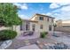 Outdoor dining on the patio with spacious gravel and rock landscaping in this suburban backyard at 7183 Majestic Bluff Pl, Las Vegas, NV 89113