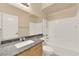 Well lit bathroom with a shower/tub combo and large vanity with a granite countertop at 7183 Majestic Bluff Pl, Las Vegas, NV 89113