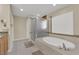 Bathroom featuring a separate shower and soaking tub with tile surround at 7183 Majestic Bluff Pl, Las Vegas, NV 89113