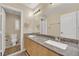 Spacious bathroom featuring double sinks, a large mirror, and upgraded lighting at 7183 Majestic Bluff Pl, Las Vegas, NV 89113