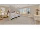 Spacious bedroom features a four poster bed and an abundance of natural light from large windows at 7183 Majestic Bluff Pl, Las Vegas, NV 89113