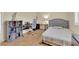 Comfortable bedroom with hardwood floors, a gray upholstered headboard, and an efficient workspace at 7183 Majestic Bluff Pl, Las Vegas, NV 89113