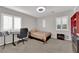 Clean bedroom with gray walls, carpeted floor, shutters, and a small wardrobe at 7183 Majestic Bluff Pl, Las Vegas, NV 89113