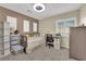 Cozy bedroom with plush carpet, stylish shutters, and plenty of natural light at 7183 Majestic Bluff Pl, Las Vegas, NV 89113