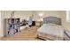 Bedroom with wood floors, piano, desk and tufted gray headboard at 7183 Majestic Bluff Pl, Las Vegas, NV 89113