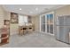 Bright breakfast area with a table, stainless steel refrigerator, and access to the outdoors through sliding glass doors at 7183 Majestic Bluff Pl, Las Vegas, NV 89113