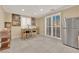 Dining area with a table and chairs, plantation shutters, and a stainless steel refrigerator at 7183 Majestic Bluff Pl, Las Vegas, NV 89113