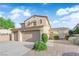 Two-story home with a three-car garage, desert landscaping, and a sunny sky background at 7183 Majestic Bluff Pl, Las Vegas, NV 89113