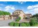 Two-story home with three-car garage, well-manicured landscaping, and a sunny sky background at 7183 Majestic Bluff Pl, Las Vegas, NV 89113