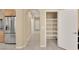 Hallway view showing the pantry with ample shelving and stainless steel refrigerator at 7183 Majestic Bluff Pl, Las Vegas, NV 89113