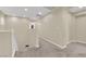 Hallway with carpet and white trim and an arched doorway at 7183 Majestic Bluff Pl, Las Vegas, NV 89113