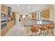 Spacious kitchen featuring stainless steel appliances, a large island, and seating at the breakfast bar at 7183 Majestic Bluff Pl, Las Vegas, NV 89113
