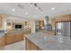 Open-concept kitchen with granite countertops, stainless steel appliances, and easy access to the living space at 7183 Majestic Bluff Pl, Las Vegas, NV 89113